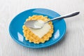 ÃÂ¡ondensed milk and spoon on wafer cookie in blue saucer Royalty Free Stock Photo